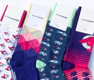 4 pairs of branded socks that Training Tracker ordered to help them fundraise, hand out at events, send to prospective clients, and give to employees