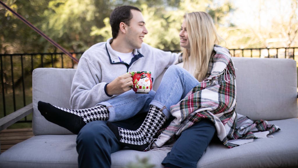 Couple sitting on couch wearing custom socks