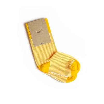 Branded yellow striped sock packaging on a youth sock with logo and kraft paper