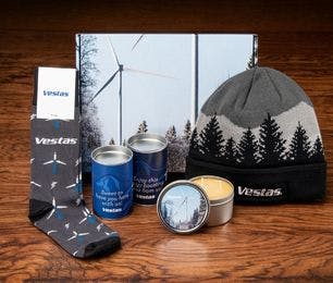 Custom kit that 1338Tryon made for Vestas including Sock Club custom dress socks, a knit beanie, a candle, and cookies in a branded box