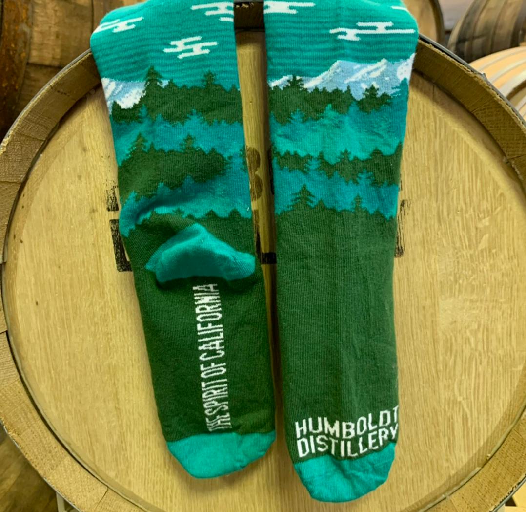 Blue and green tree landscape logo socks for Humboldt Distillery 