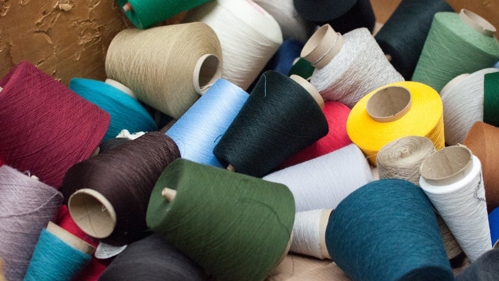 Collection of multi-colored yarn spools for custom socks