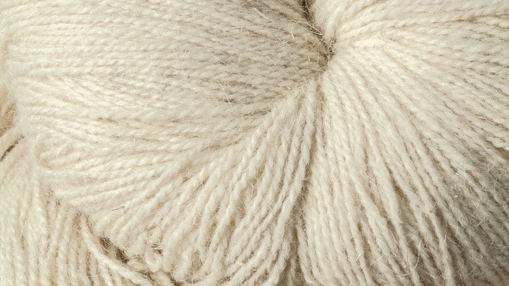 Undyed wool yarn coiled together