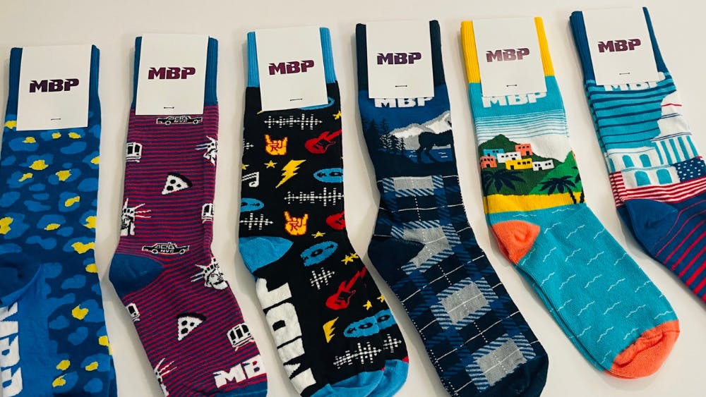 six pairs of MBP custom design socks for trade show swag