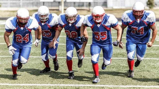 Football team running down the field showing their football socks