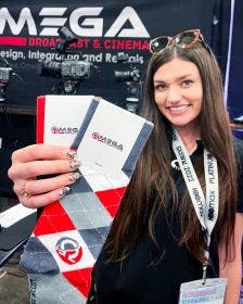 Omega Broadcasting holding up the custom socks that they used as trade show giveaways