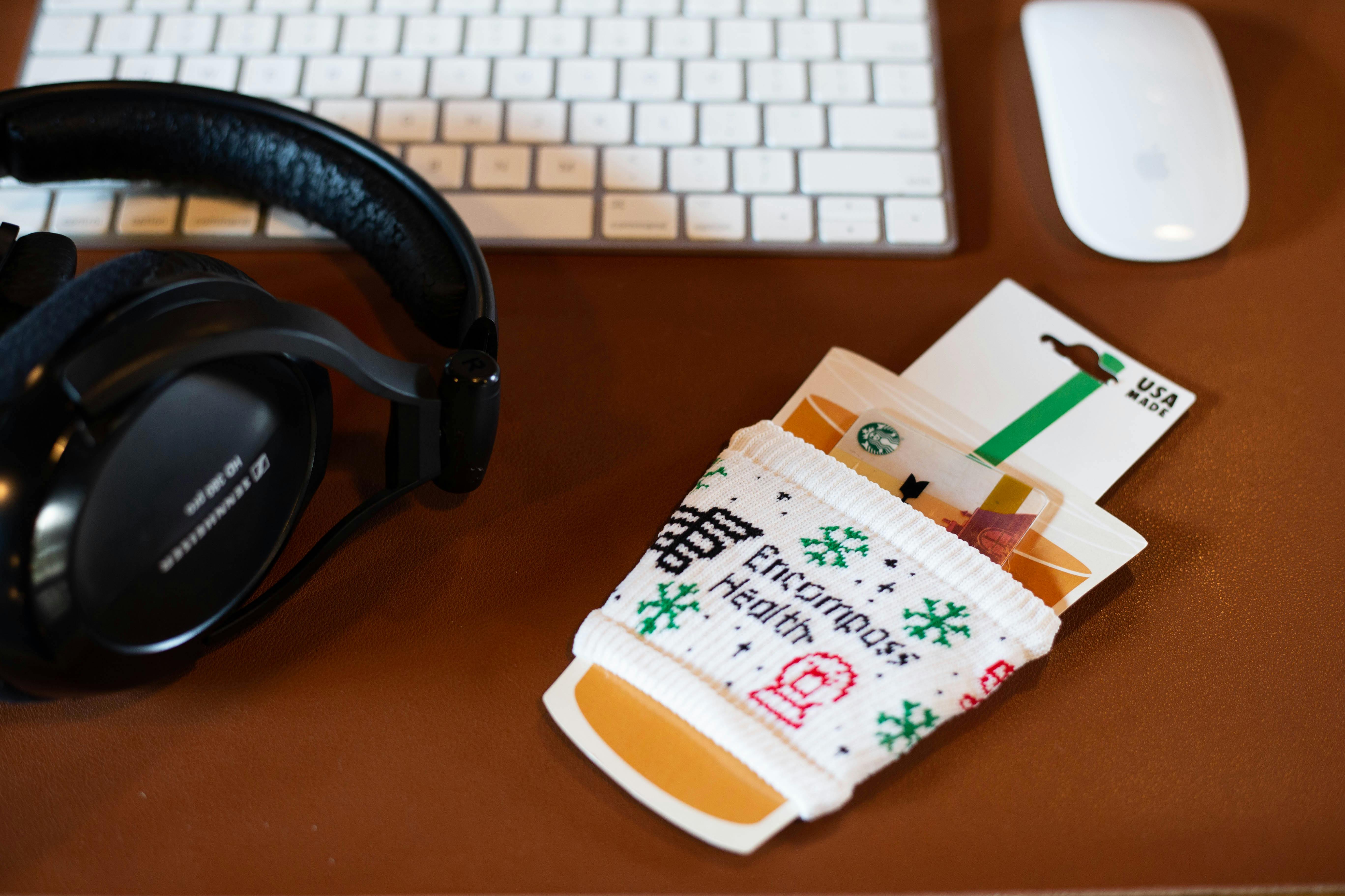 Holiday themed white slippy in custom coffee cup packaging on desk 