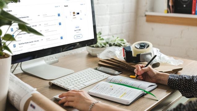 A brand manager working on a new company swag store at her desk in her home office