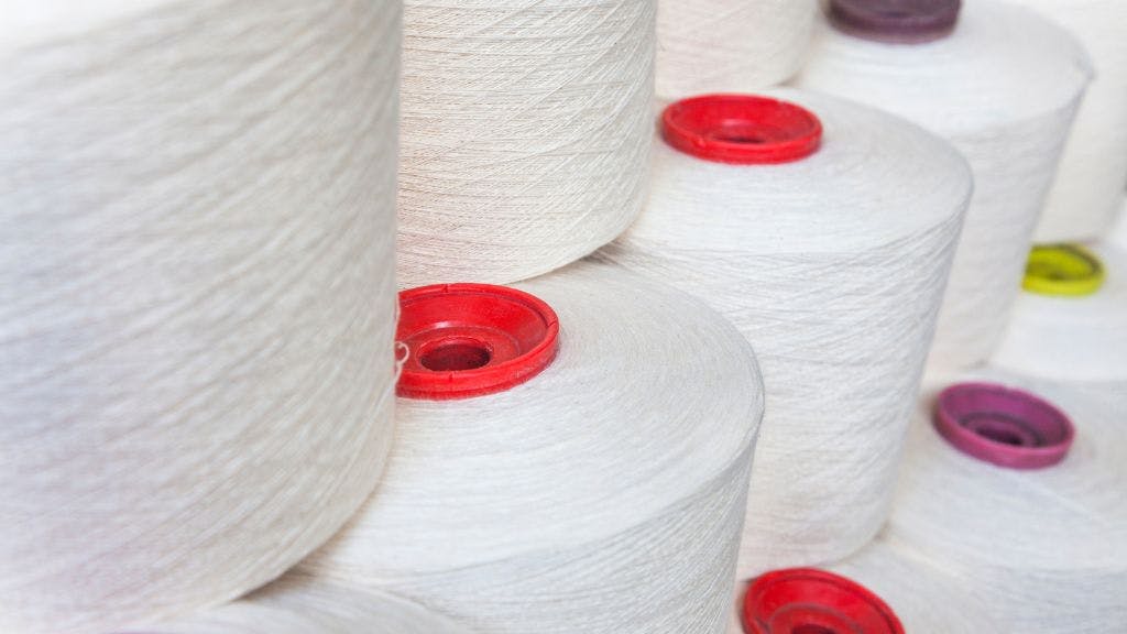 Spools of undyed and bleached cotton yarn