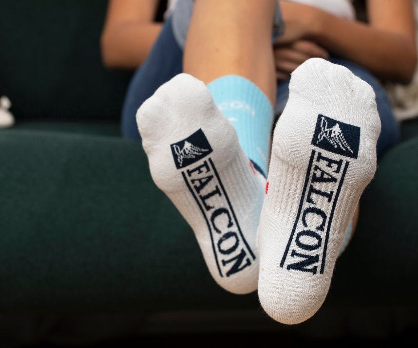 Custom athletic socks for Falcon showing their logo on the bottom of the socks