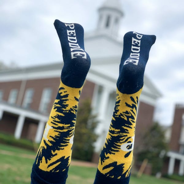 The Peddie School navy blue and yellow tye dye custom logo socks