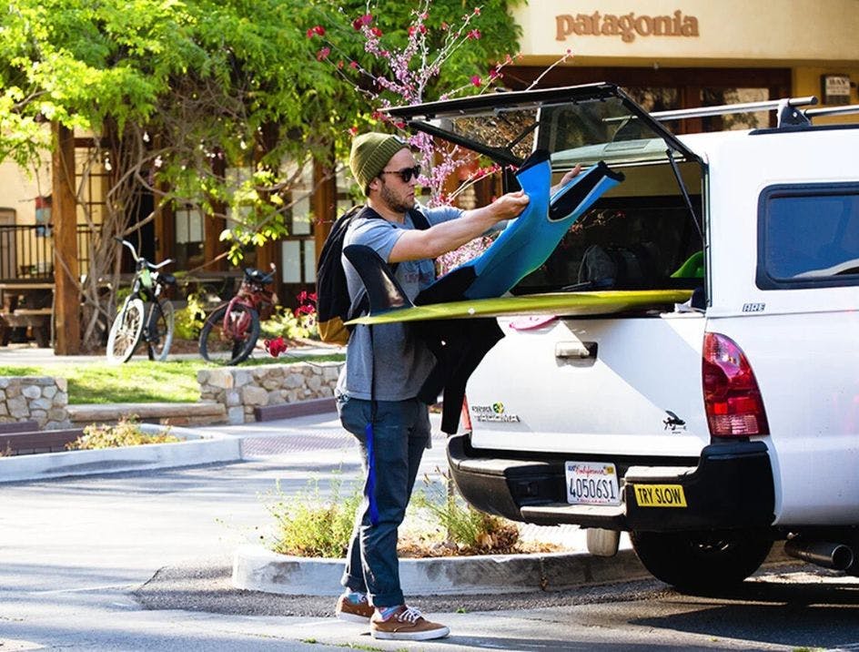 Am employee outside of the Patagonia office getting in his truck and taking a break from work to go surfing