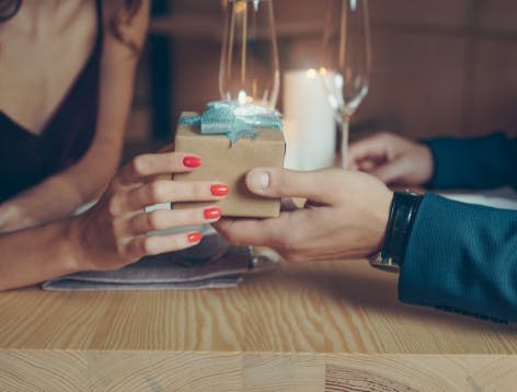 Man and woman exchanging personalized gift