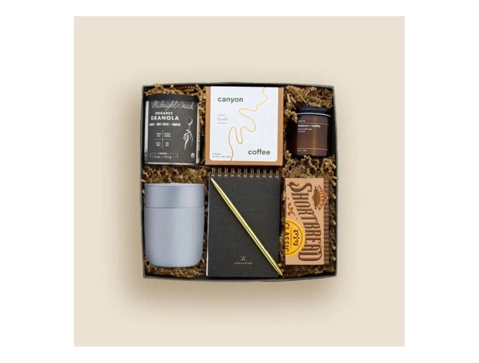 The Office Essentials Kit from Teak & Twine including an assortment of items to enhance any workday, including productivity tools and treats for a morning or afternoon pick-me-up.