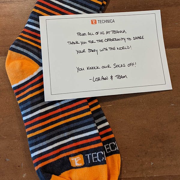 Orange and grey striped custom logo sock for Technica Communications with personalized note