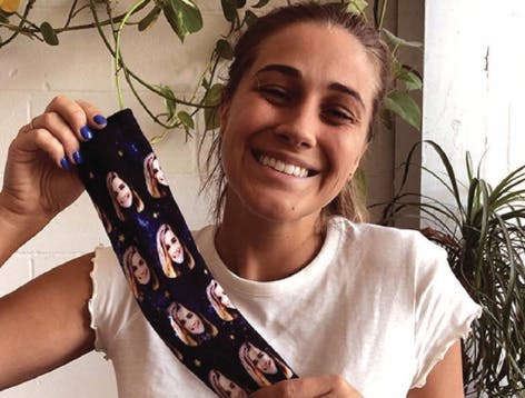 Woman smiling about purple face socks gift