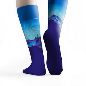 The back of Kiva Confections blue landscape socks on feet