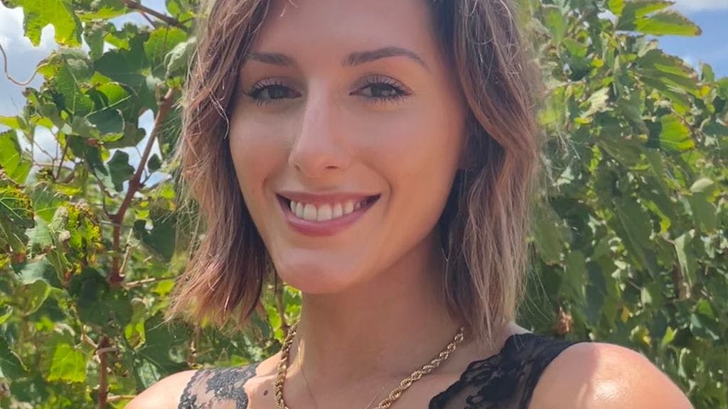 Email Marketing Manager Tatiana Arnold with lush trees in the background on a sunny day