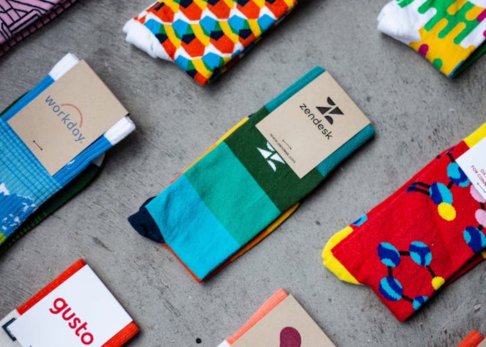 custom socks with logo by sock club laying on concrete
