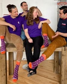 The Talent.com team with their custom socks with logo that they made for employee appreciation gifts