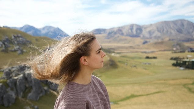 E-Commerce Manager Abby Gilligan on a hike showing a vast view of the mountains and the sky in the background