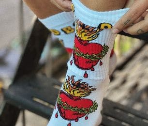 Custom socks for the Old Bones Society E-Commerce store featuring in intricate tattoo design of a heart with a crown of thorns from artist Matt Adamson
