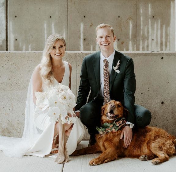 Bride Brittany and Groom Jonathan with the inspiration behind their custom socks, their dog