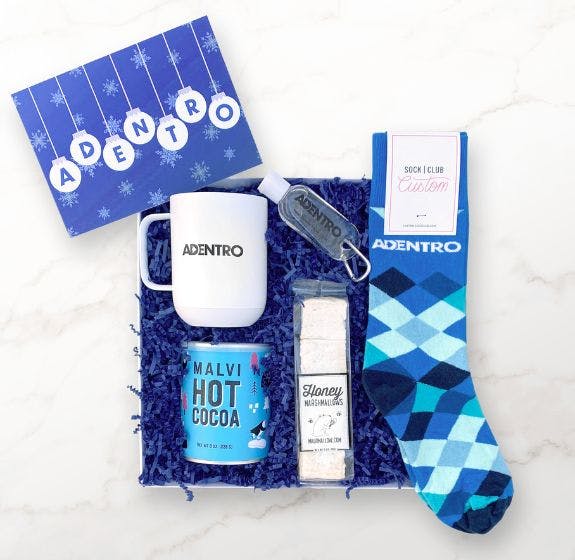 Custom curated corporate gift box by Palisades Canyon featuring blue argyle custom socks from Sock Club