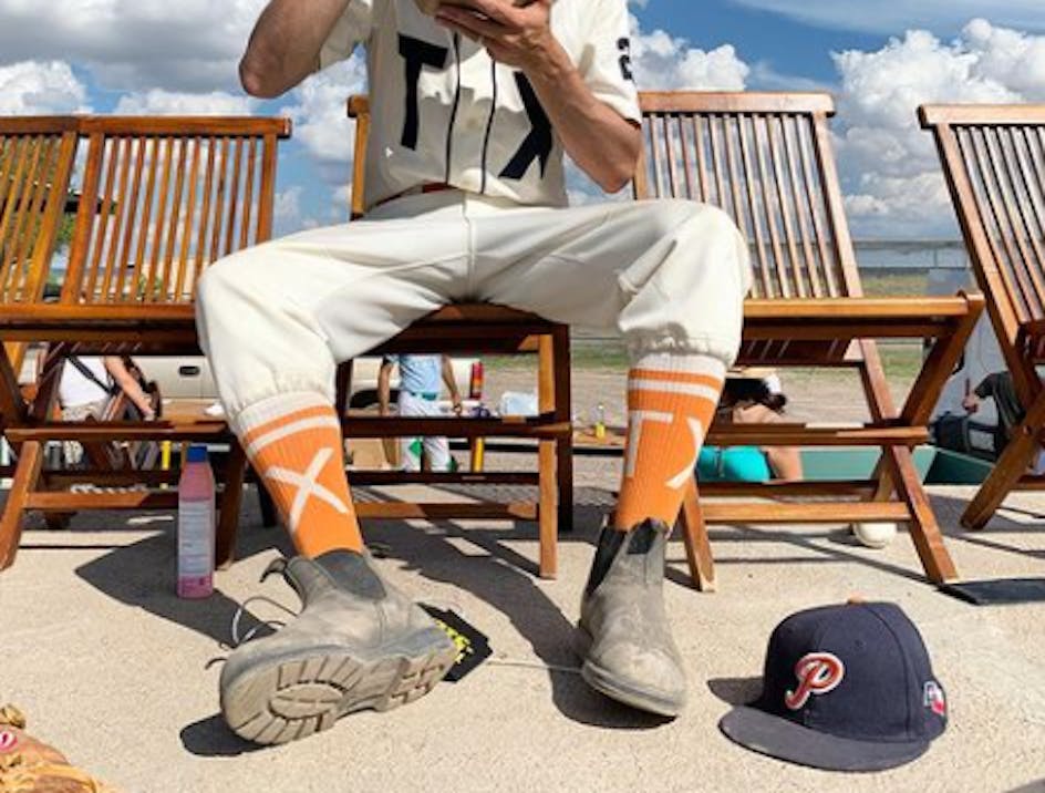 Texas Playboys player wearing orange custom baseball socks 