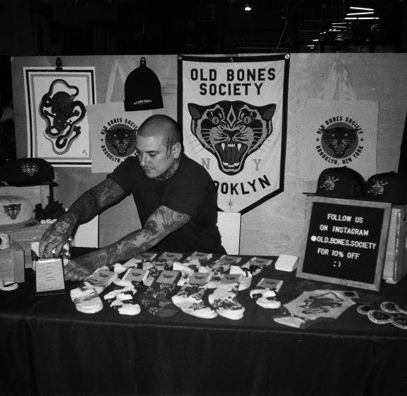 Old Bones Society pop-up shop in Brooklyn with Matt Adamson setting up the booth