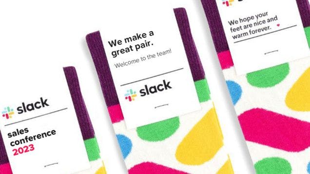 Three branded socks for Slack with different messaging on the custom sock header cards, including "we make a great pair" and "we hope your feet are nice and warm forever."