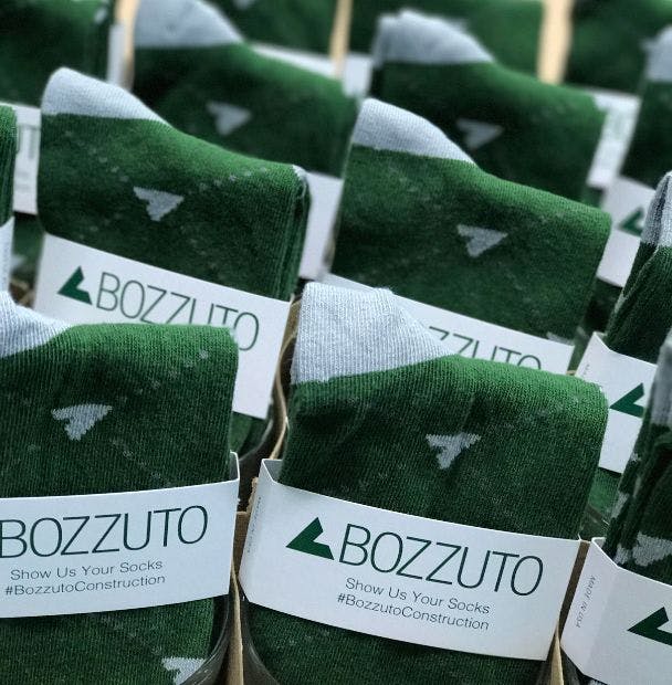 Bulk custom sock as a trade show giveaway for Bozzuto Construction