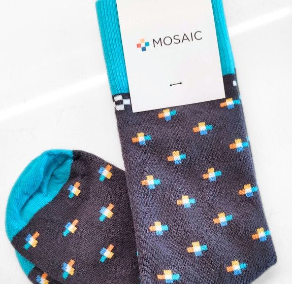 Custom socks with a repeating logo pattern on a grey background for solar energy company Mosaic