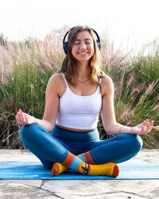 woman doing yoga for an employee wellness initiative in custom socks
