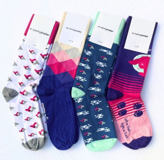 4 pairs of branded socks that Training Tracker ordered to help them fundraise, hand out at events, send to prospective clients, and give to employees