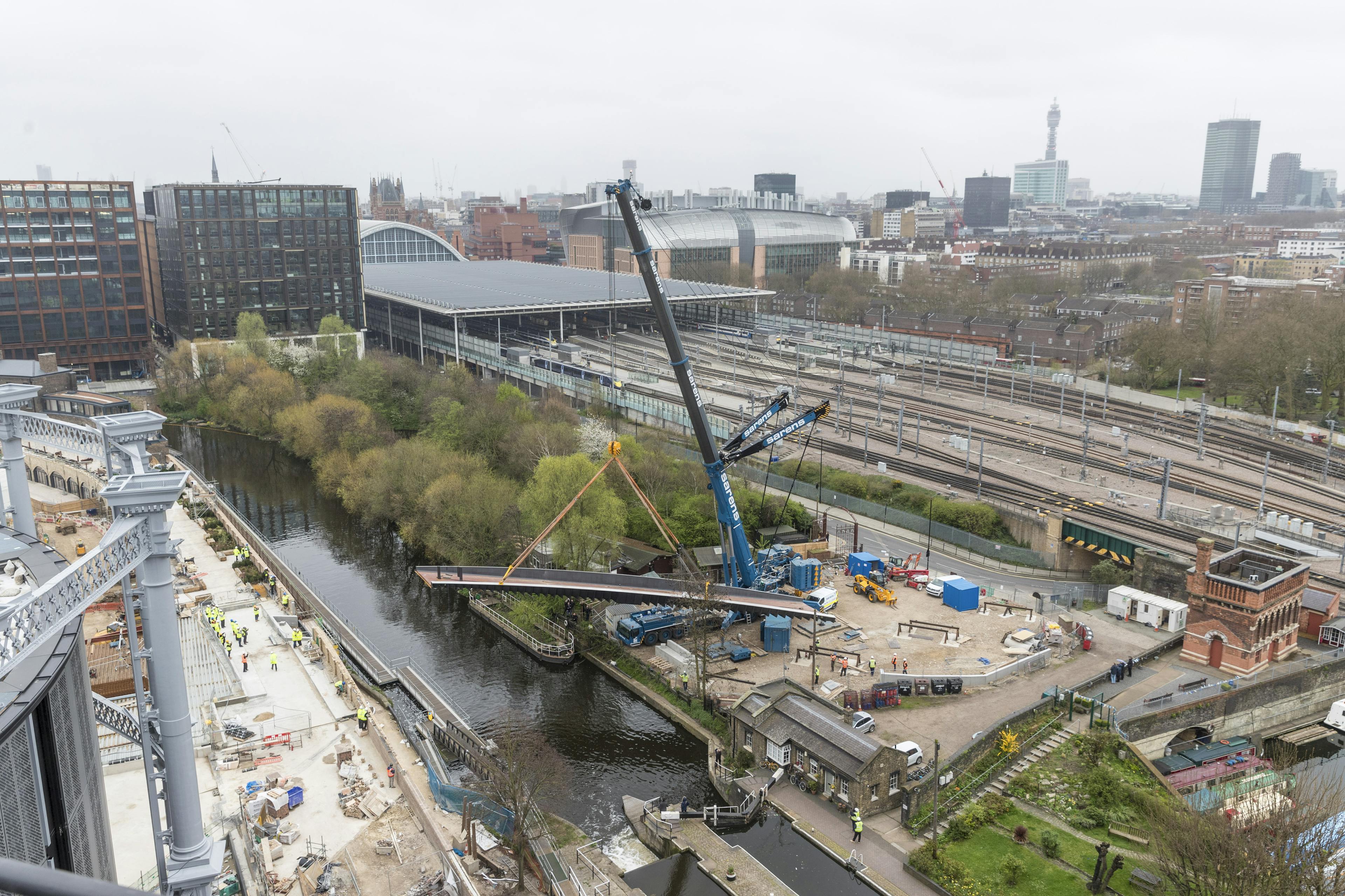 Bridge being lifted into place by a crane.