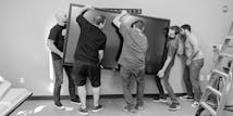 Some of the SoCreate Team are lifting a 300-pound touch conference room display.  This was one of many as we have them in every room at the SoCreate HQ.