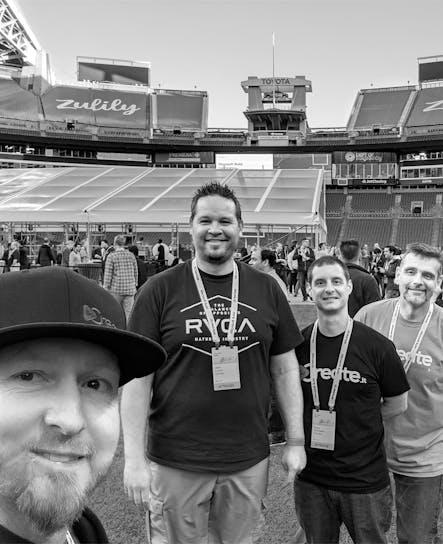 Some of the SoCreate Development Team are on the field of the Seattle Seahawks Stadium.