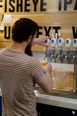 Brewery server pouring a beer in Toronto