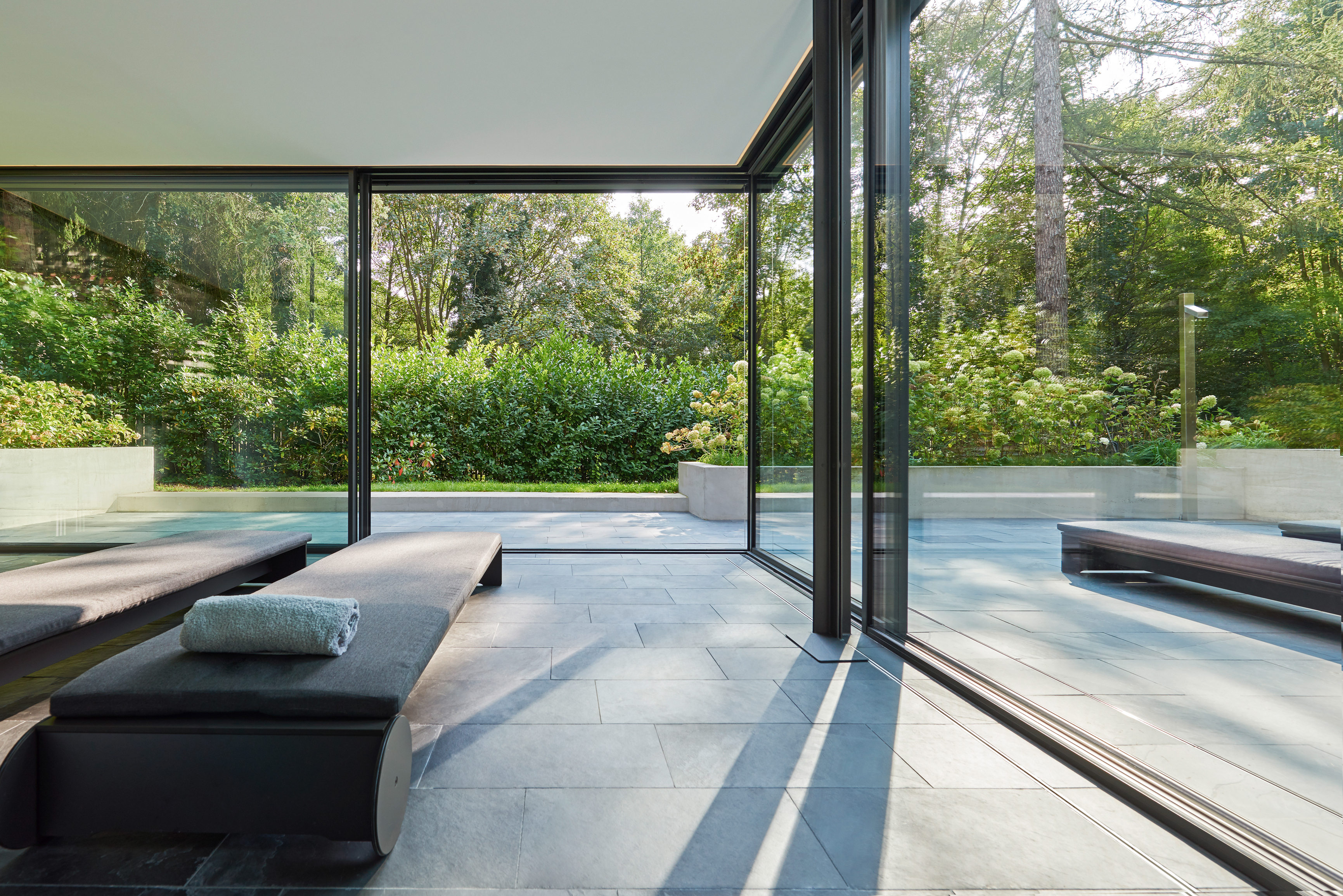 spa area of home with expansive sliding doors and lounge beds