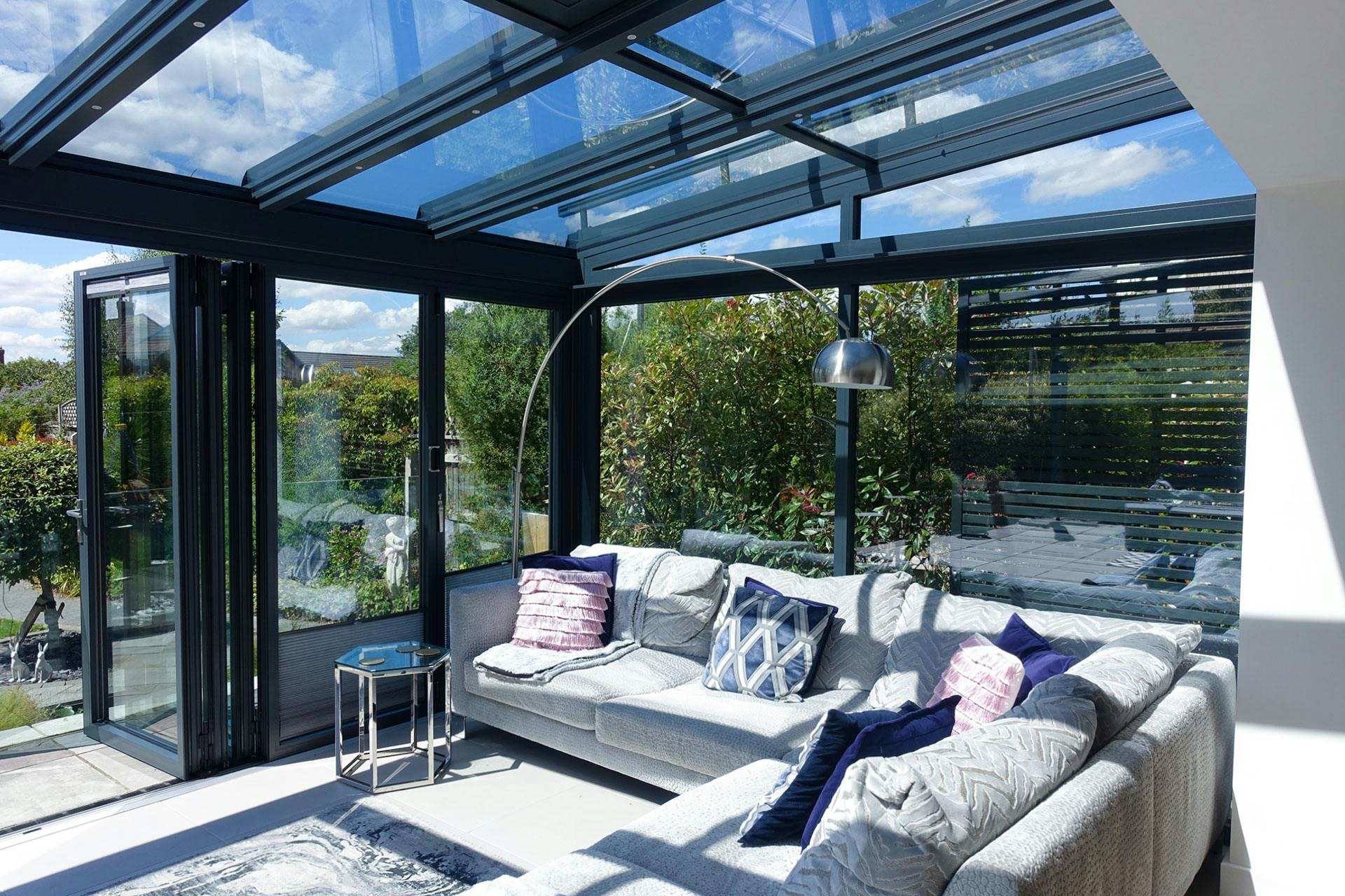 bright and airy garden room with white sofa in summer