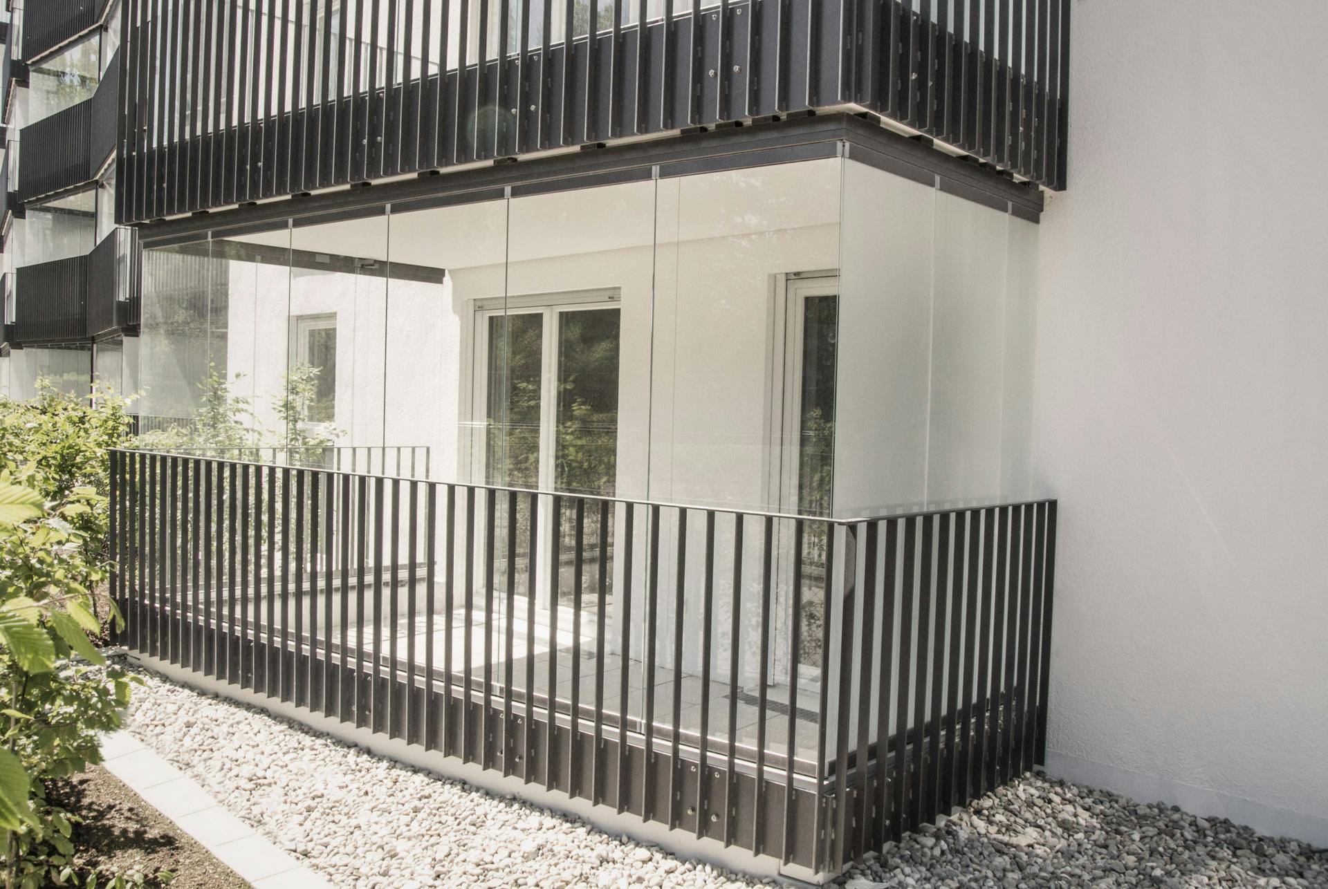white building with balcony and glass doors