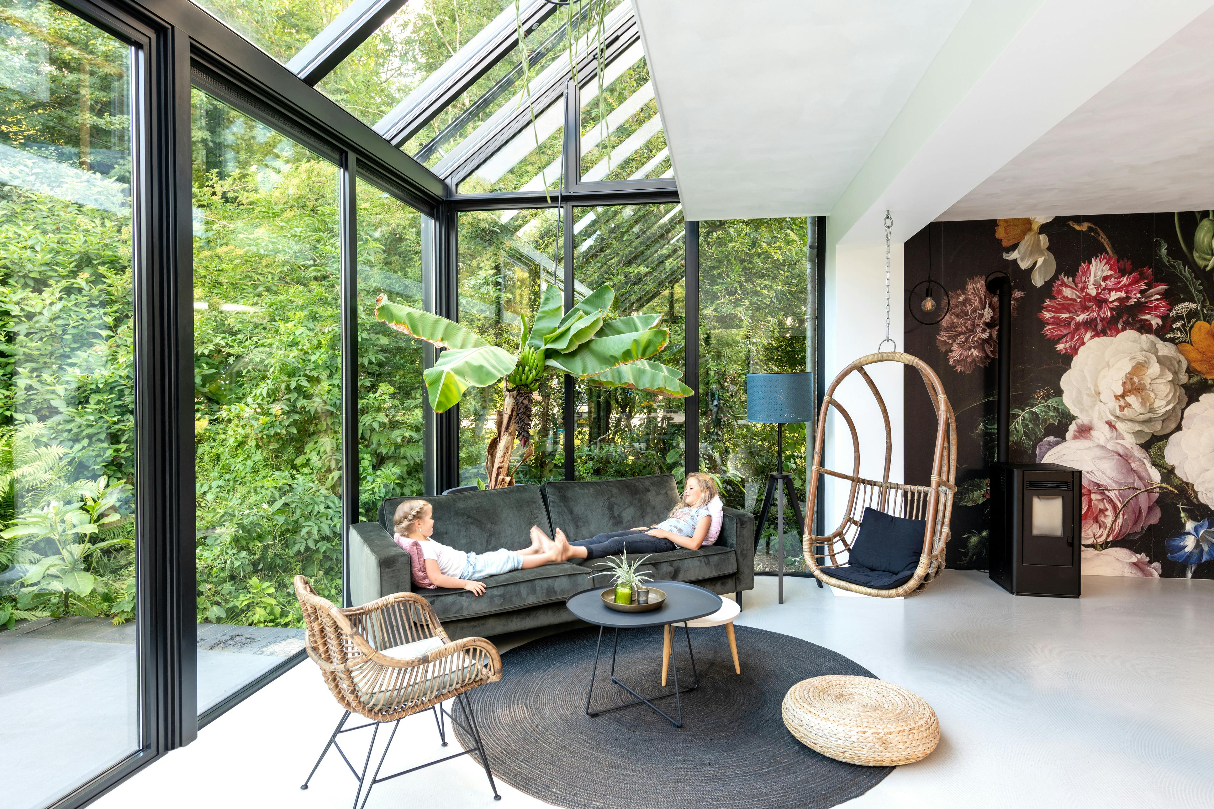two girls in modern living room made of glass