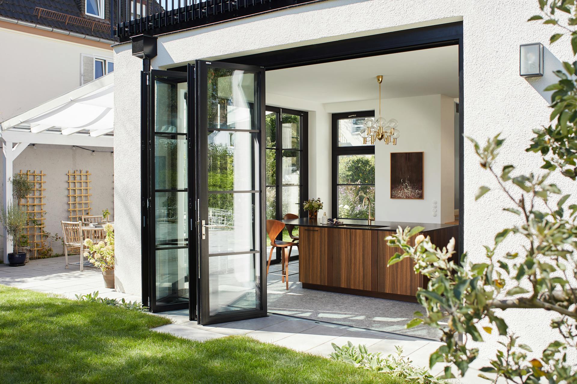kitchen with black framed glass bifolds onto garden