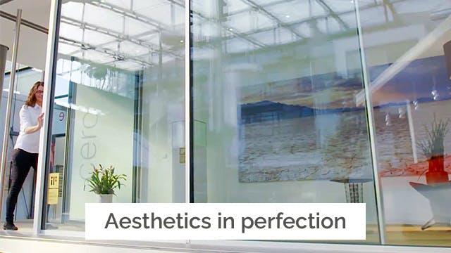 Lady pushing open large Cero glass sliding doors in her home