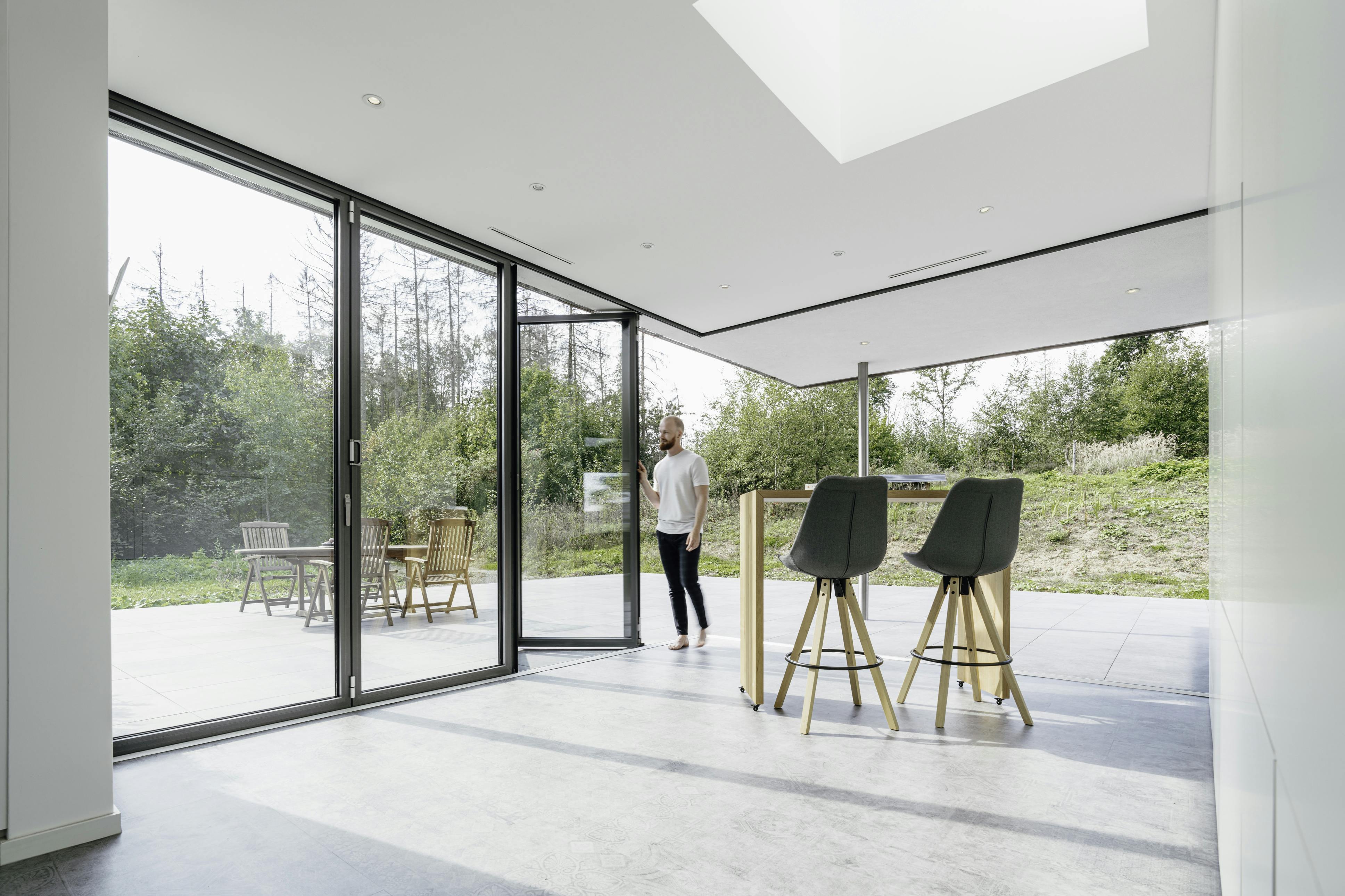 white room with desk and chairs and open corner bifolding doors