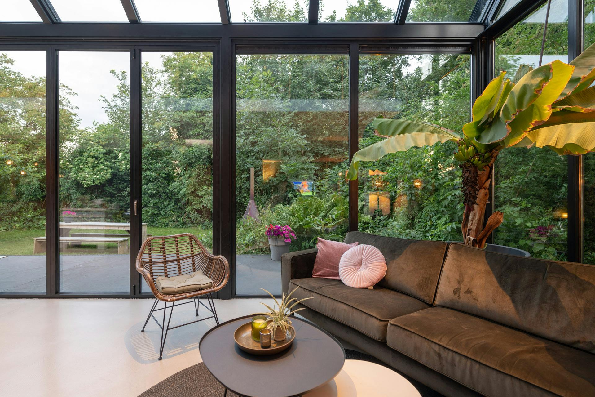 cosy living room in earthy tones with glass windows and doors for ample natural light