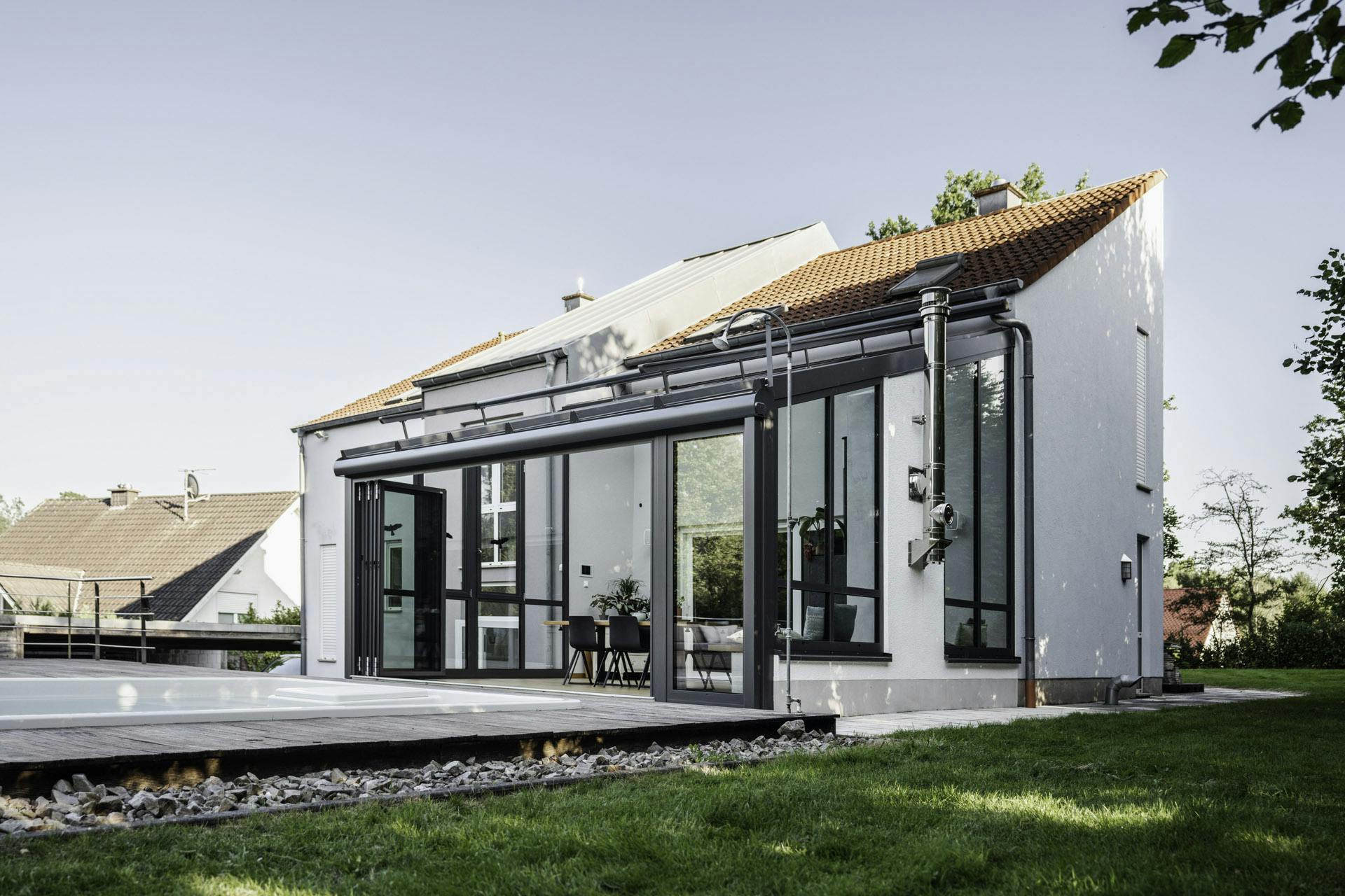 Solarlux wintergarden glass extension on home with swimming pool