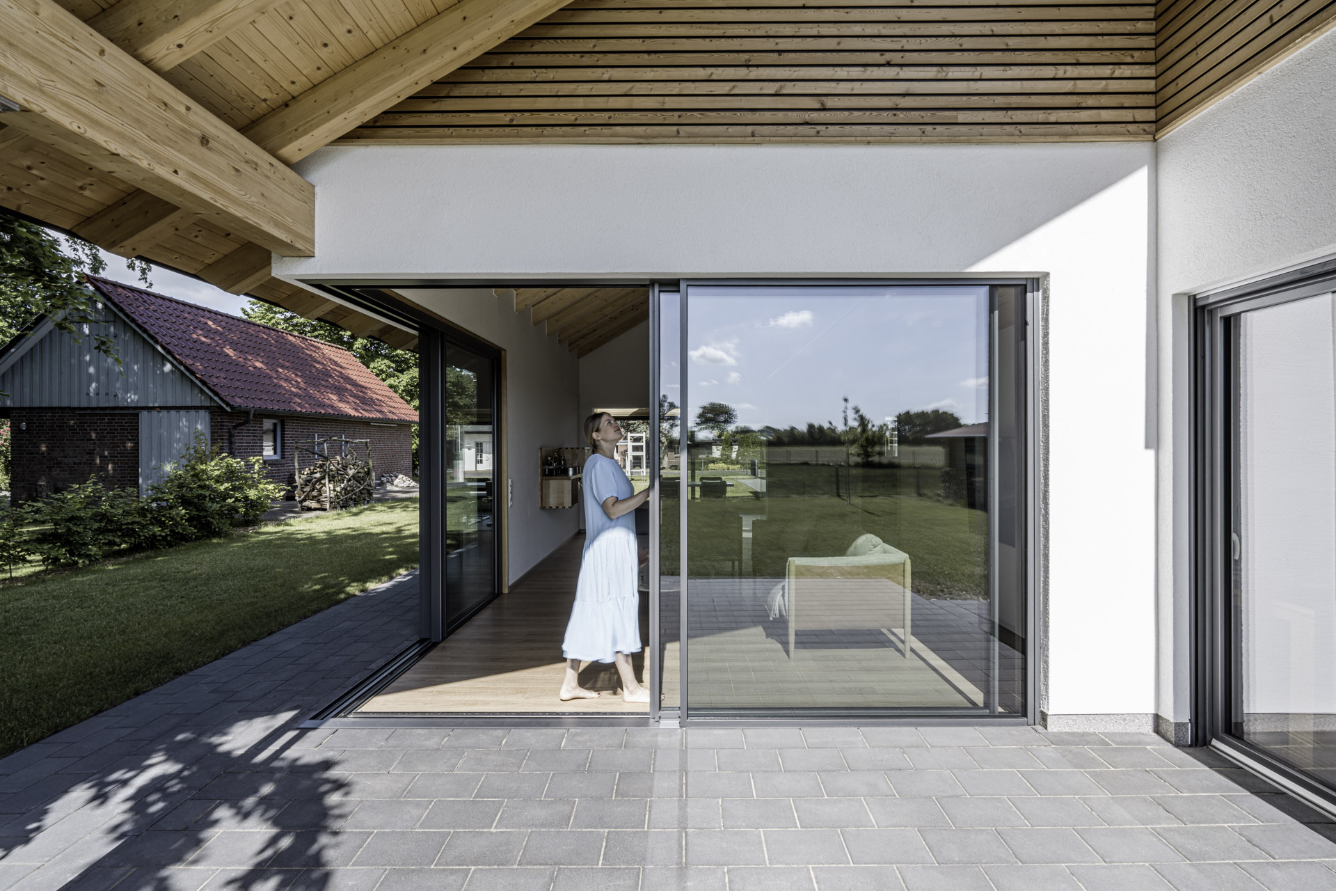 lady opening a Solarlux sliding door Hull