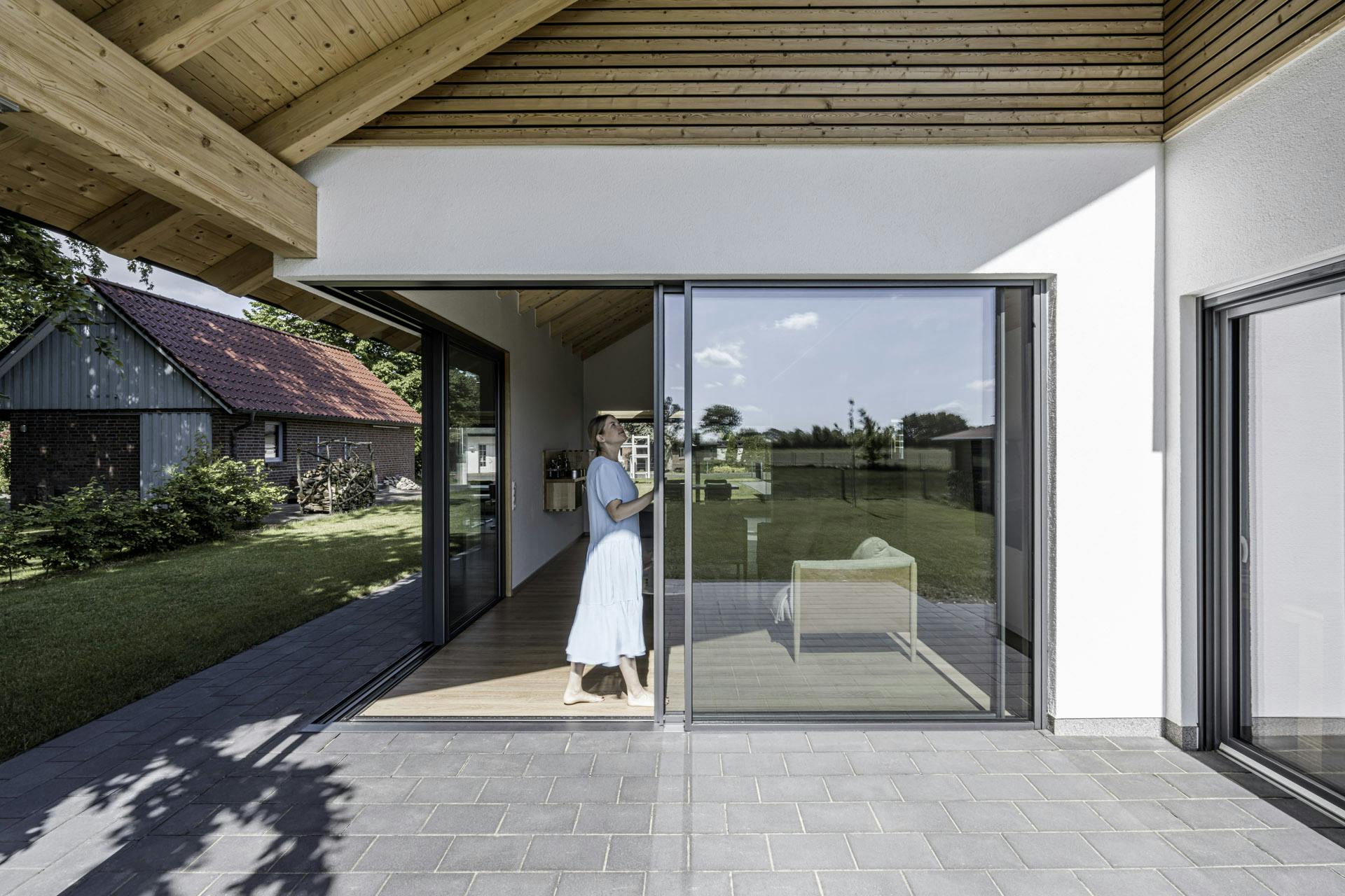 lady opening a Solarlux sliding door Hull